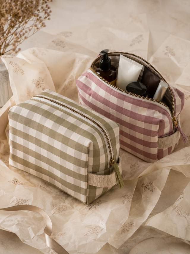 Hand block-printed toiletry kits in floral and gingham prints for men and women.