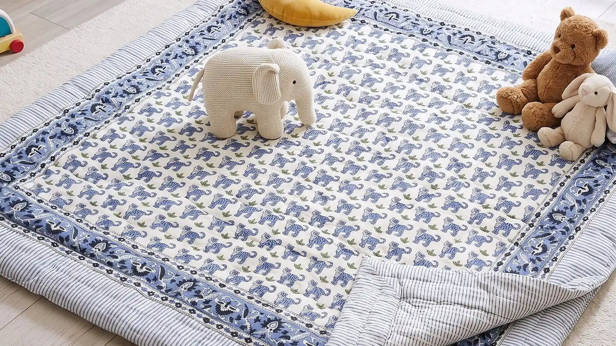 A PEXX cotton quilt spread on a playroom floor