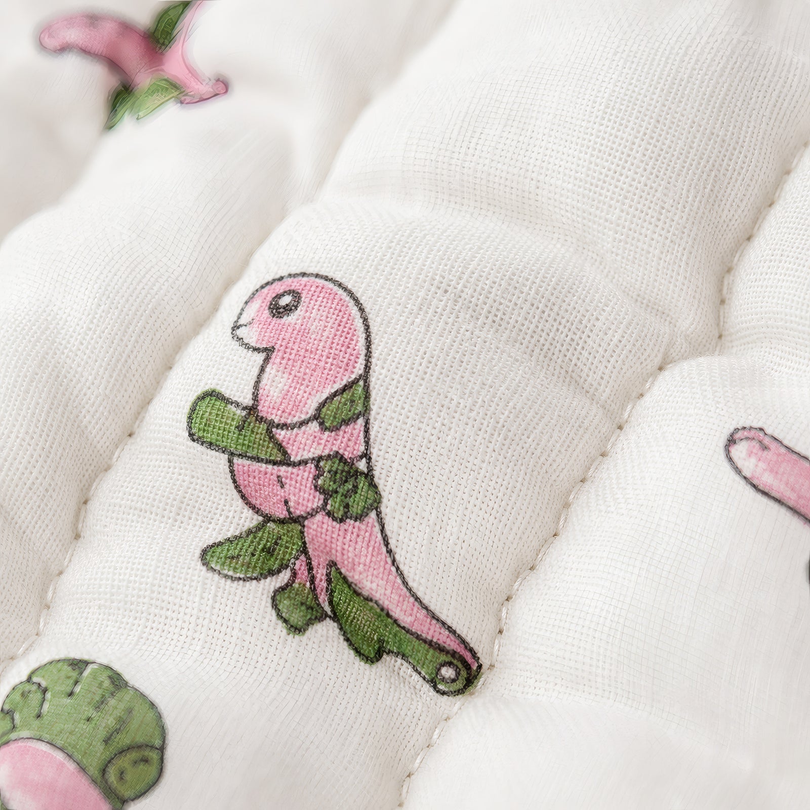 PEXX pink dino print reversible cotton baby quilt, 100 x 100 cm — dino print close up