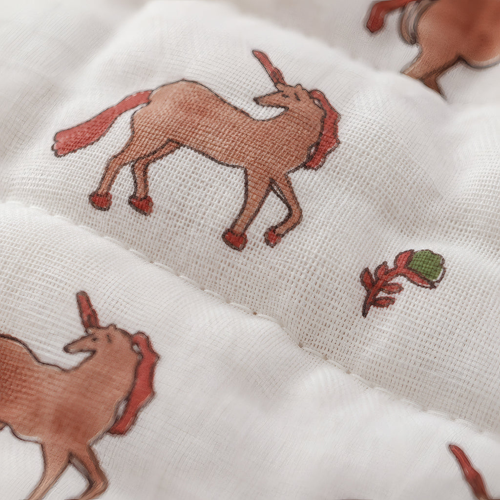 PEXX terracotta unicorn print reversible cotton baby quilt, 100 x 100 cm — unicorn print close up